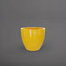 Wannsee Extra Large Round Fiberglass Planter in gloss saffron against gray background.