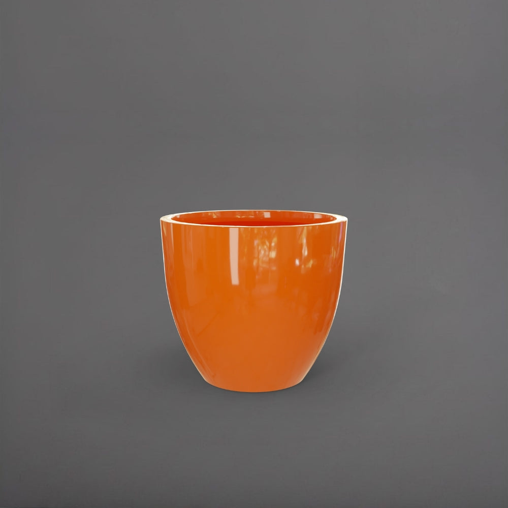 Wannsee Extra Large Round Fiberglass Planter in gloss tangerine against gray background.