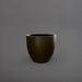 Wannsee Extra Large Round Fiberglass Planter in matte bronze against gray background.