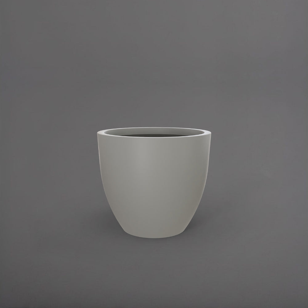 Wannsee Extra Large Round Fiberglass Planter in matte cement grey against gray background.