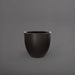 Wannsee Extra Large Round Fiberglass Planter in matte charcoal against gray background.