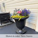 Williamsburg Egg and Dart urn planter in black finish filled with flowers near entrance to home.