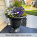 Williamsburg Egg and Dart planter in black finish filled with colorful flowers near home front entrance.
