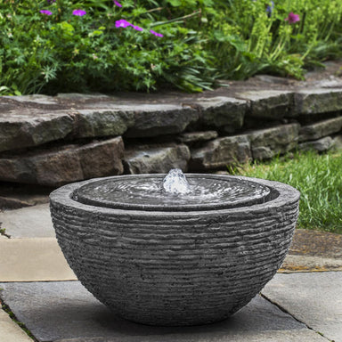 Arroyo Fountain Stone Ledge in action on concrete patio in backyard