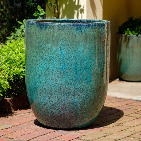 Brantome Planter Weathered Copper S/3 on bricks in backyard