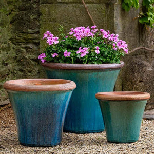Brighton Planter - Mediterranean Set of 3 filled with pink flowers in the backyard