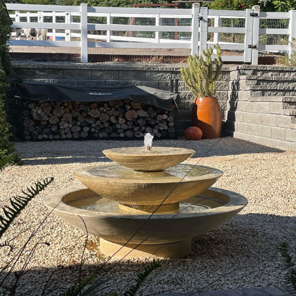 Campania cascade fountain on gravel in backyard running