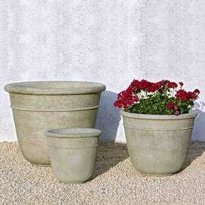 Carema Large Planter with two smaller planters on gravel near white wall