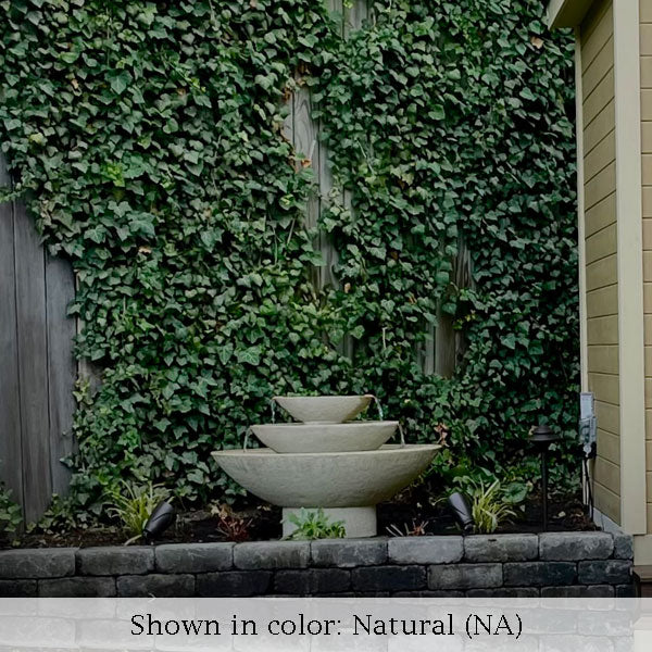 Carrera oval fountain in front of ivy wall in action