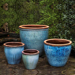 Chandor Planter - Rustic Blue Set of 4 against green plants in the backyard