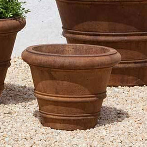 Classic Rolled Rim 11.5" Planter on gravel against wall in the backyard