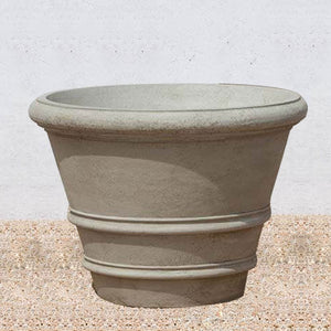 Classic Rolled Rim 35.5" Planter on gravel against cream wall
