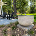 Echo park fountain in action in backyard near two black adirondack chairs