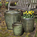 Ellesmere Planter S/3 Green Metallic near a chair in the backyard 