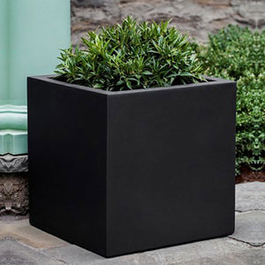 Farnley Planter 2424 - Onyx Black Lite S/1 on concrete filled with plants