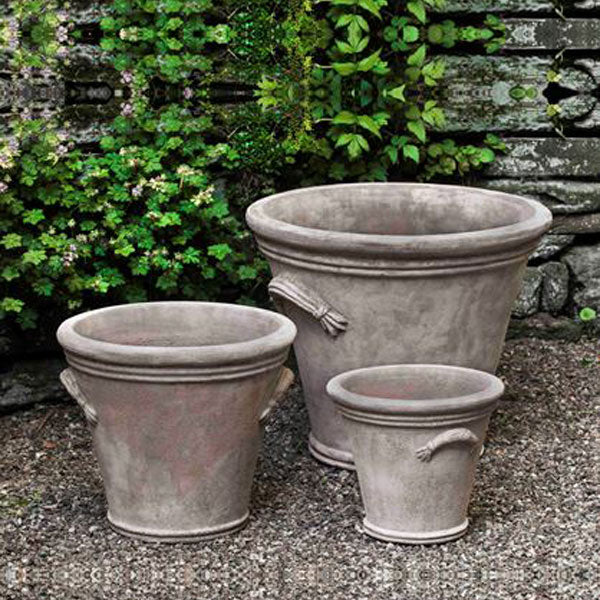 Flued Handle Planter Antico Terra Cotta S/3 on gravel in the backyard