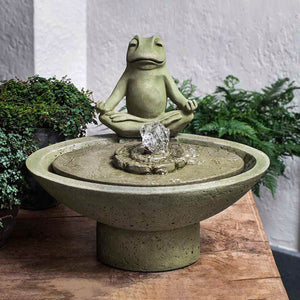 Garden Terrace Meditation Fountain on table beside green plants 