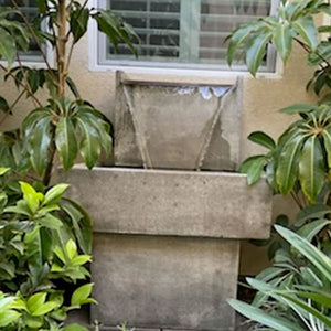 gray fountain with copper spiller