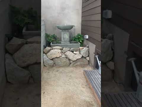 Austin Fountain running in large boulder rock garden