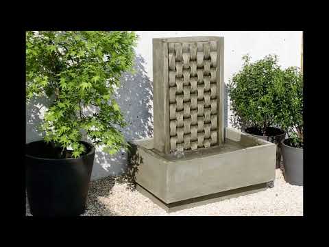 Campania M Weave fountain on white gravel in backyard running