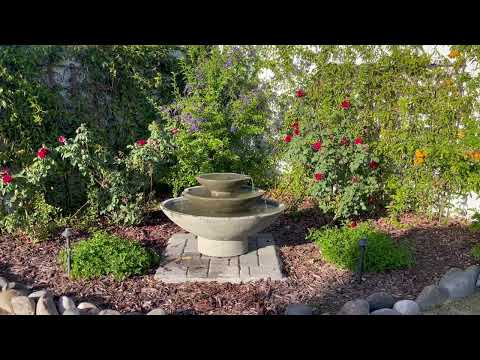 Campania Carrera Oval Fountain next to flowers