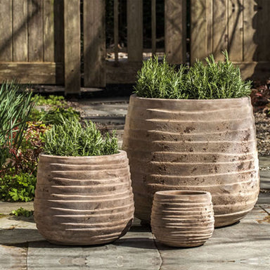 Ipanema Planter - Antico Terra Cotta S/3 filled with plants in the backyard