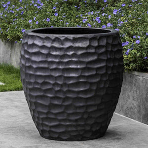Kowloon Planter Graphite S/2 against purple flowers in the backyard