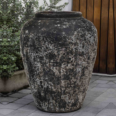 Larissa Jar Planter Aegean on concrete beside green plants