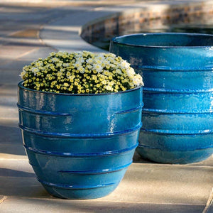 Logis Planter, Short - Cerulean Blue - S/2 filled with yellow flowers near a swimming pool