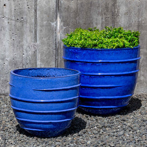 Logis Planter, Short - Riviera Blue S/2 on gravel filled with plants