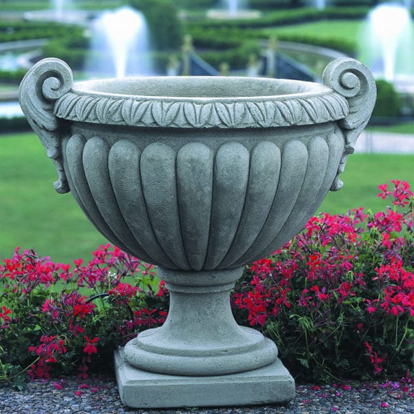 Longwood Volute Handle Urn on graphite stone against red flowers