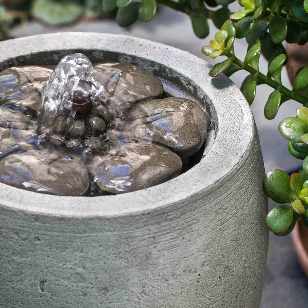 M-Series Camellia Fountain on concrete in the backyard upclose