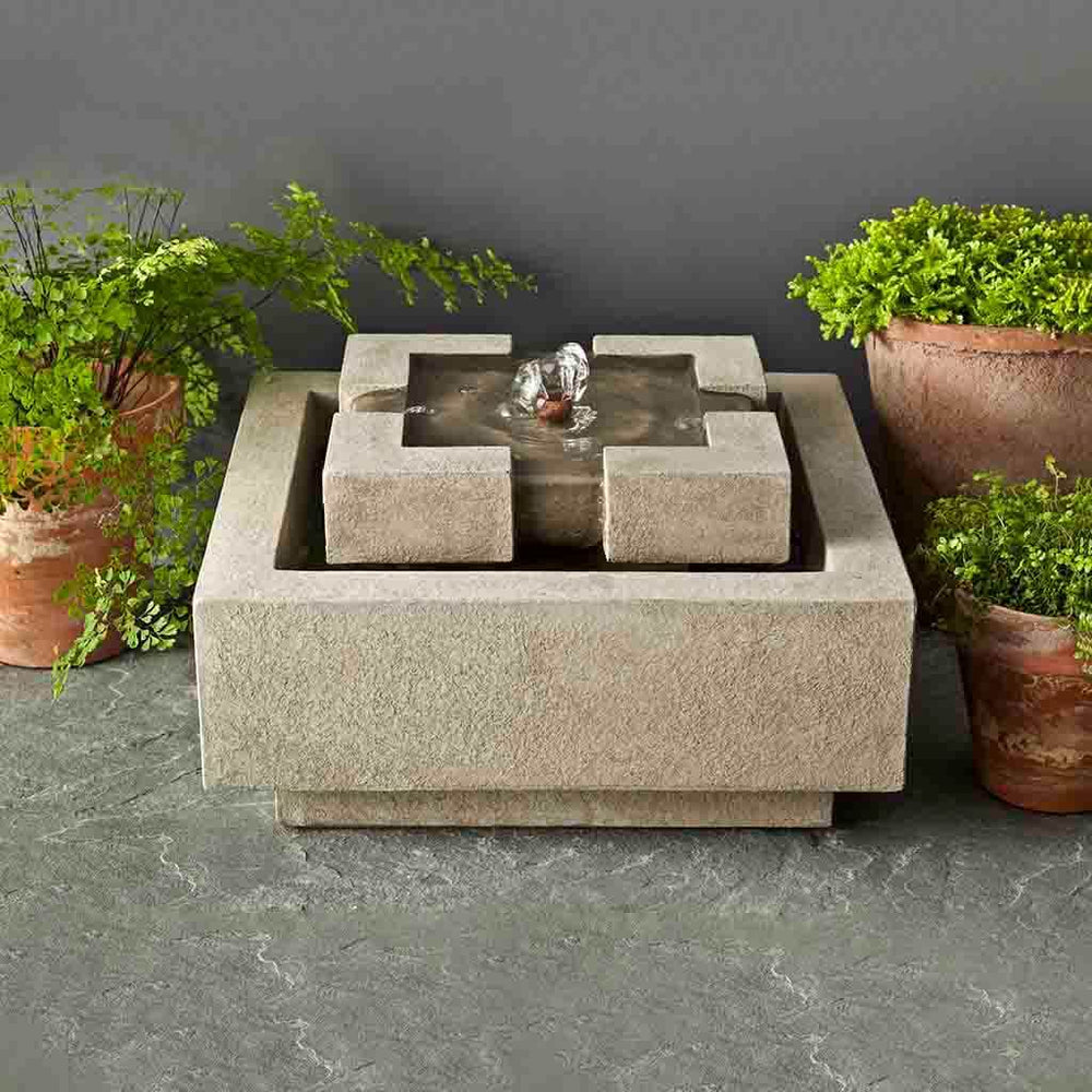 M-Series Escala Fountain on concrete beside green plants