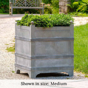 Manoir Medium Planter Zinc S/1 filled with plants in the backyard
