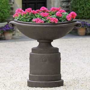 Medici Planter, Large on gravel filled with pink flowers