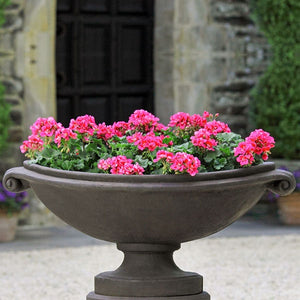 Medici Planter, Large on gravel filled with pink flowers upclose