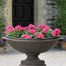 Medici Planter, Large on gravel filled with pink flowers upclose