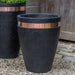 Moderne Tapered Planter on gravel beside planter filled with plants