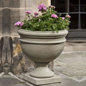 Montgomery Urn on stone filled with pink flowers