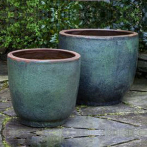 Nari Planter - Rustic Green Set of 2 against green leaves in the backyard