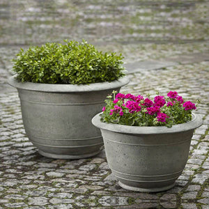 Padova Planter, Large filled with plants beside a planter filled with flowers