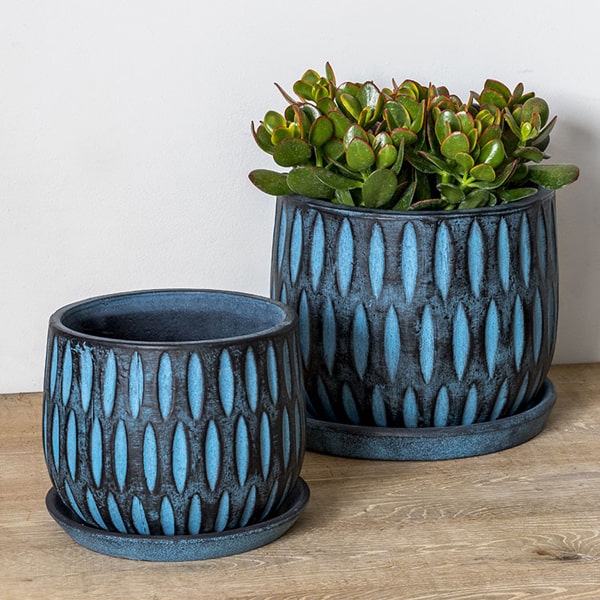 Parabola Large Round Planter - Etched Blue Set of 8 filled with plants on the table