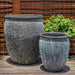 Paraiso Planter Fossil Grey S/2 on wooden floor against wall with plants