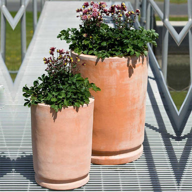 Posada Planter - Terra Cotta - S/2 filled with maroon flowers in the backyard