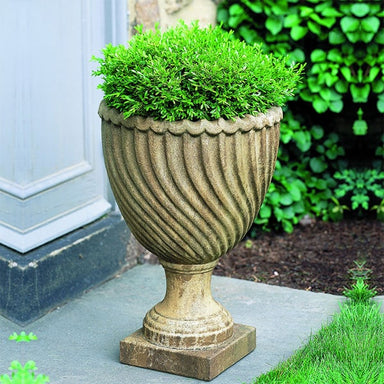 Ravenna Urn on stone filled with plants