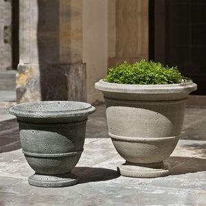 Relais Large Urn on concrete patio filled with plants