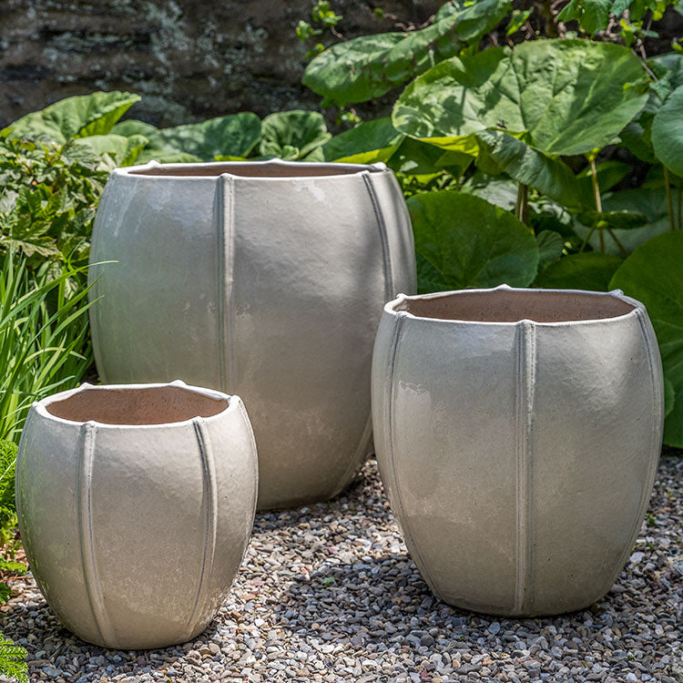 Rib Vault Planter - Cream - S/3 on gravel in the backyard