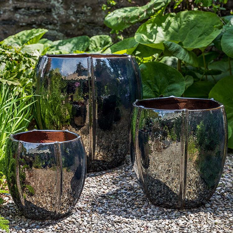 Rib Vault Planter - Metallic - S/3 on gravel in the backyard