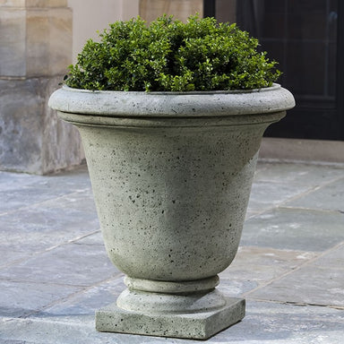 Rustic Hampton Urn on concrete patio filled with plants