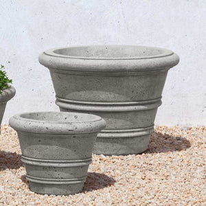 Rustic Rolled Rim 18.25 Planter on gravel in the backyard